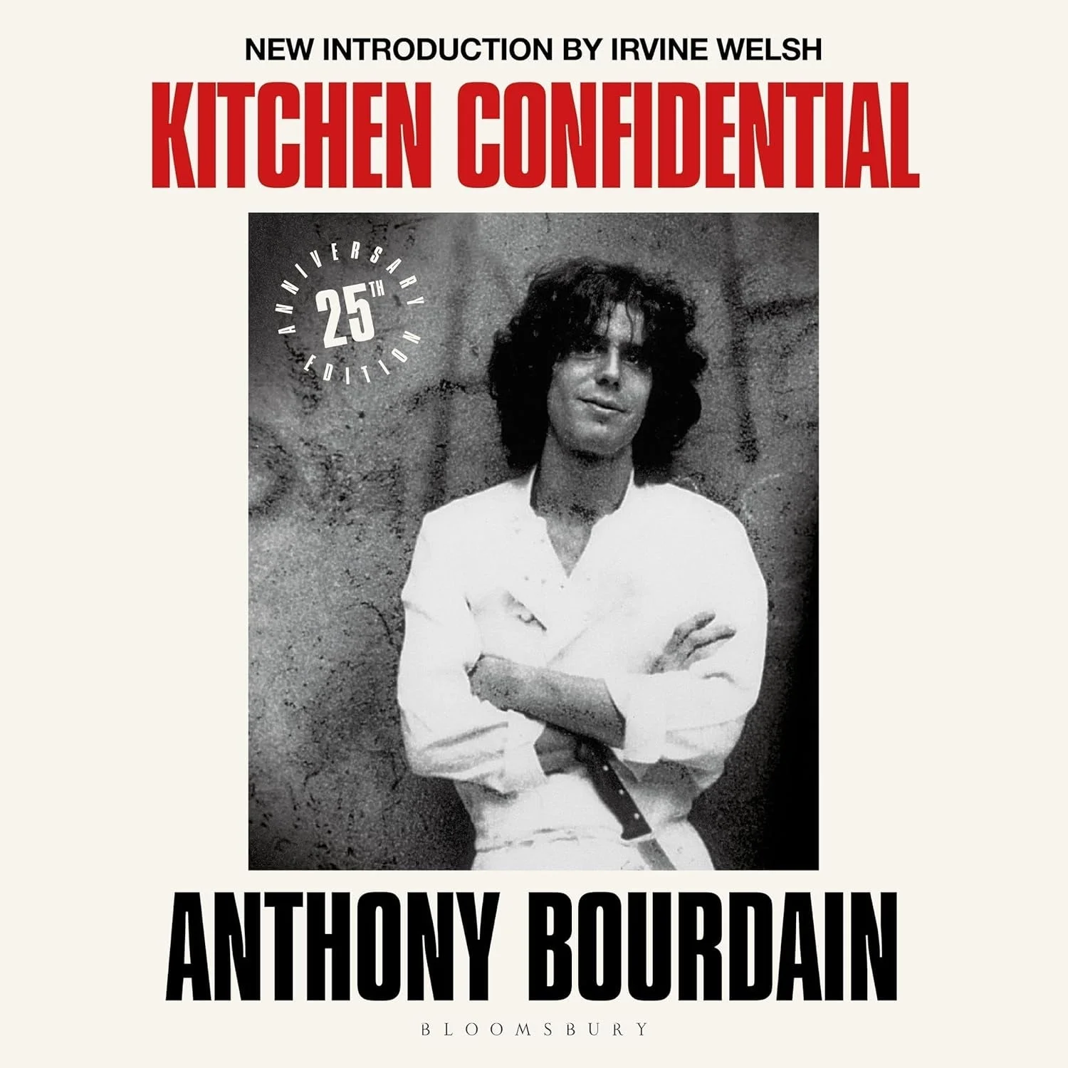 Cover of "Kitchen Confidential" 25th Anniversary Edition by Anthony Bourdain, featuring a black-and-white photo of Bourdain