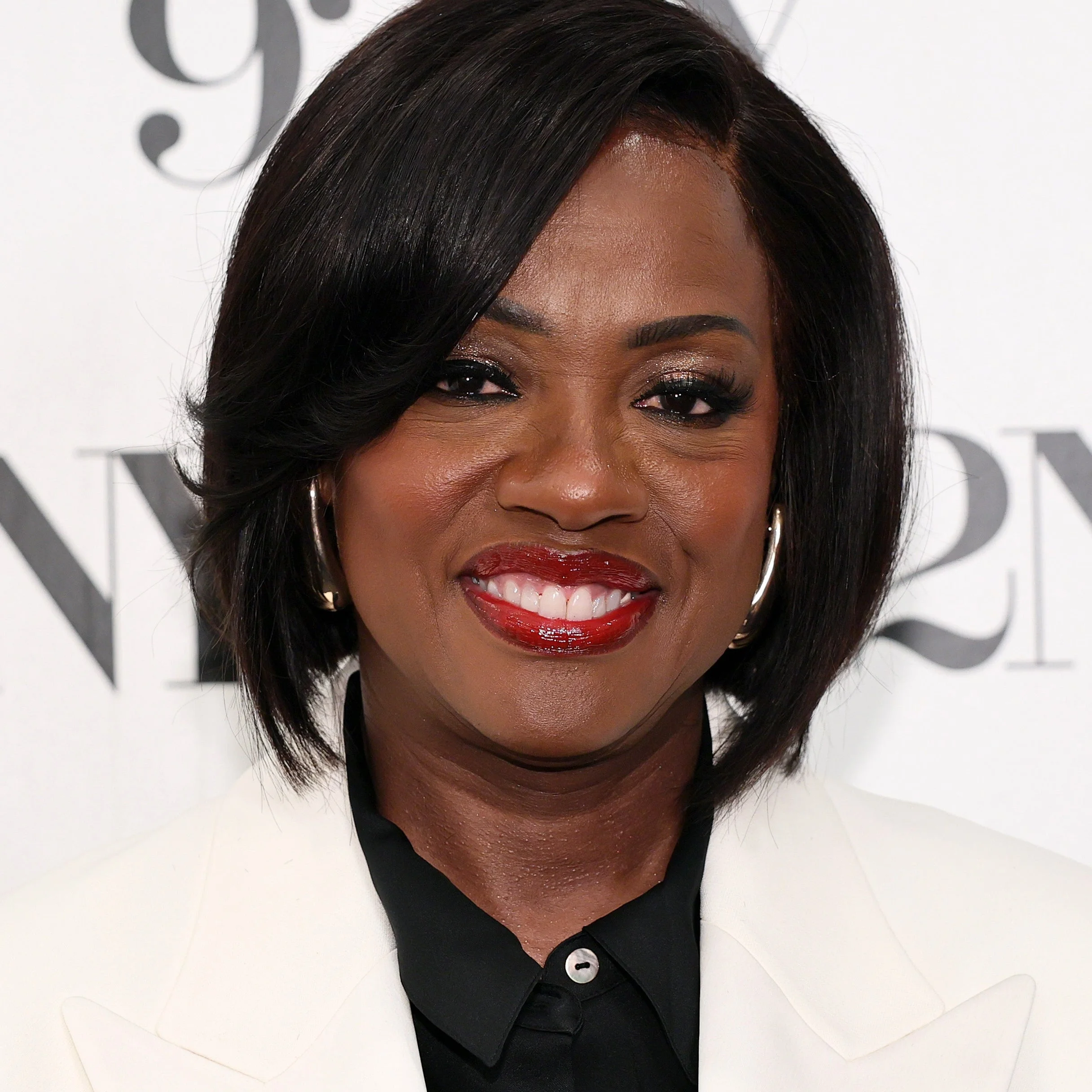 Viola Davis in a white blazer smiles while standing in front of a backdrop with "92NY" repeated