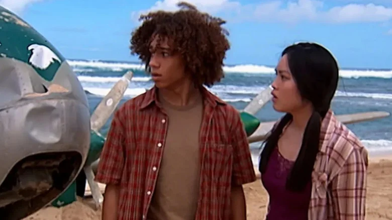 Nathan and Melissa looking at a downed plane on a beach in Flight 29 Down