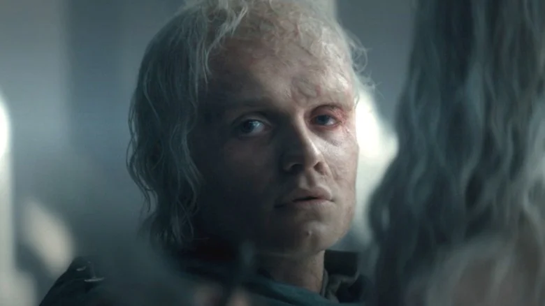 Aegon II with a sword to his brother's throat unsure if he wants to kill him in House of the Dragon