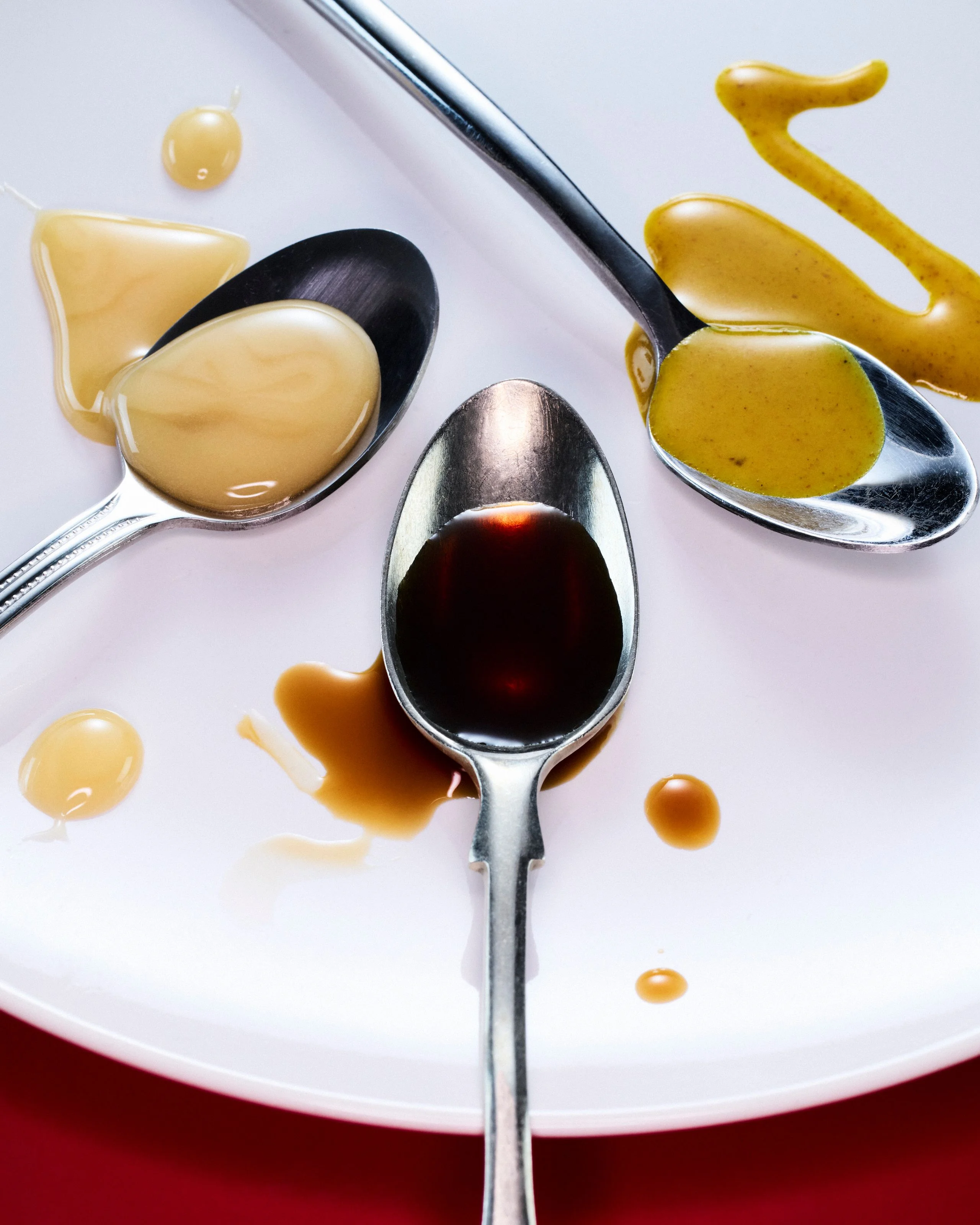 A group of sauces on alternating spoons
