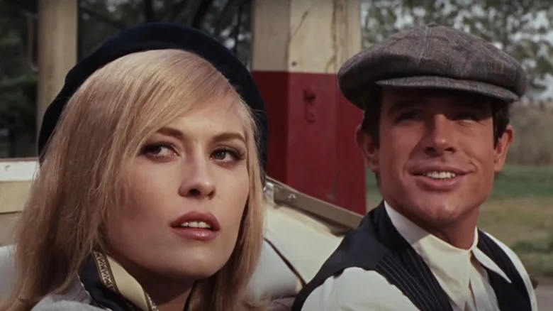 Faye Dunaway as Bonnie Parker and Warren Beatty as Clyde Barrow sit in a car in Bonnie and Clyde