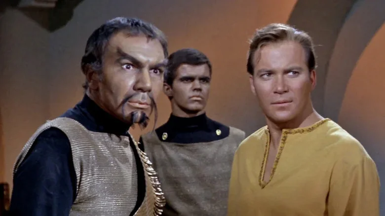 Commander Kor, a unnamed Klingon soldier, and Captain Kirk standing together on Star Trek