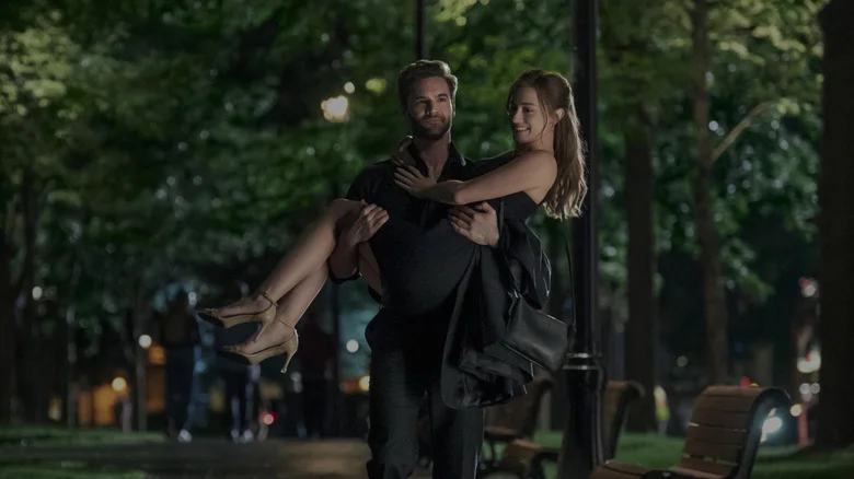 Tom carrying Olive outside in The Love Hypothesis