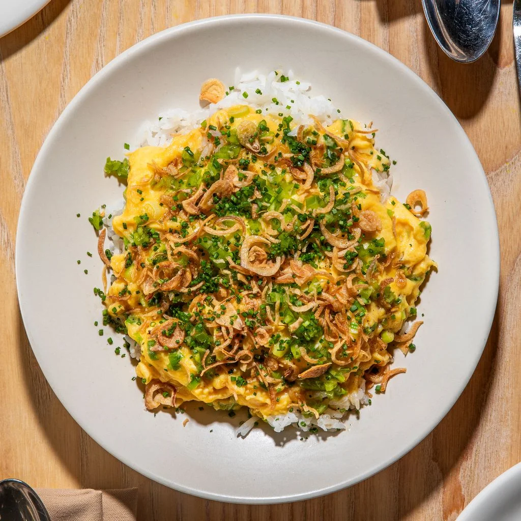 Scrambled eggs over rice and topped with fried shallots and scallion oil.