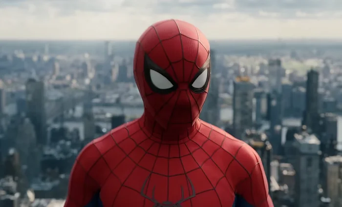 Spider-Man in costume stands on a rooftop with a cityscape view in the background