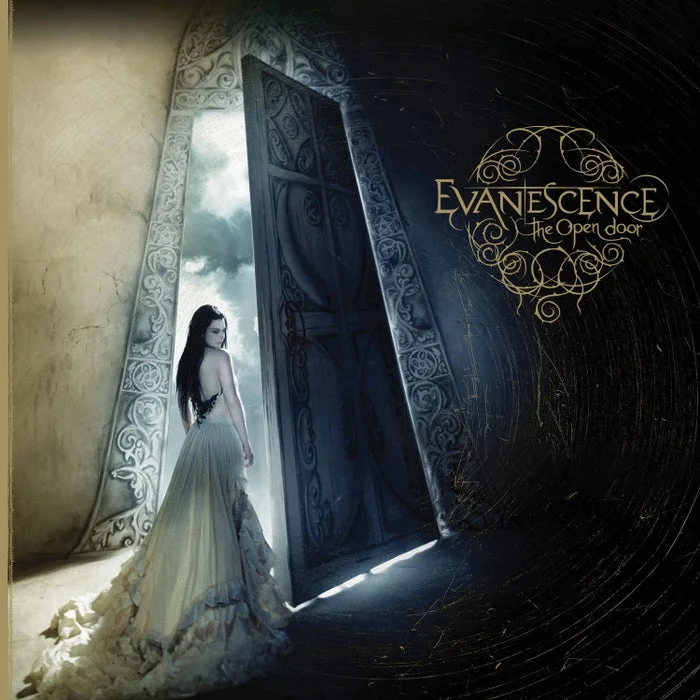 Woman in a flowing dress stands at an ornate open door with "Evanescence: The Open Door" text, evoking a mystical, ethereal theme