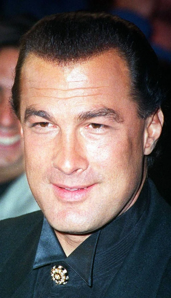 Person in a formal suit, smiling at an event