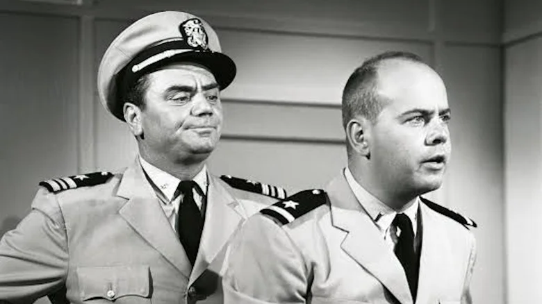 Ernest Borgnine as Lt. Cmdr. Quinton McHale looks disapprovingly over the shoulder of Tim Conway as Ensign Charles Parker in McHale's Navy
