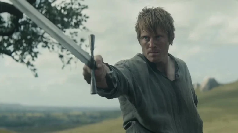 Peter Claffey as Ser Duncan "Dunk" the Tall in A Knight of the Seven Kingdoms, wielding a sword outside.