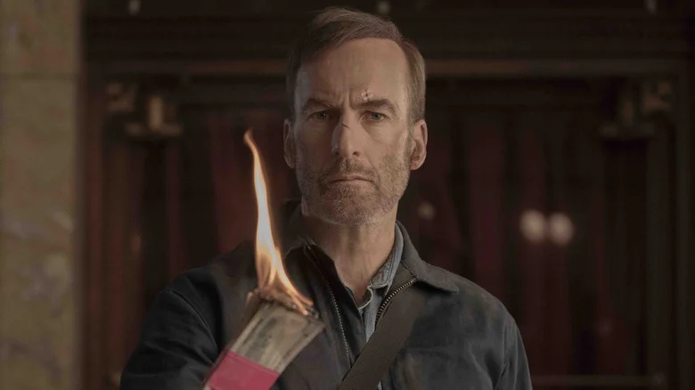 Bob Odenkirk as Hutch burning money in Nobody