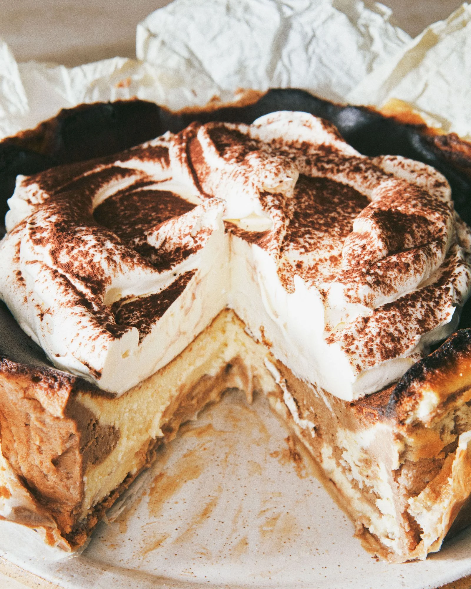 A basque cheesecake topped with whipped mascarpone and dusted with espresso powder.