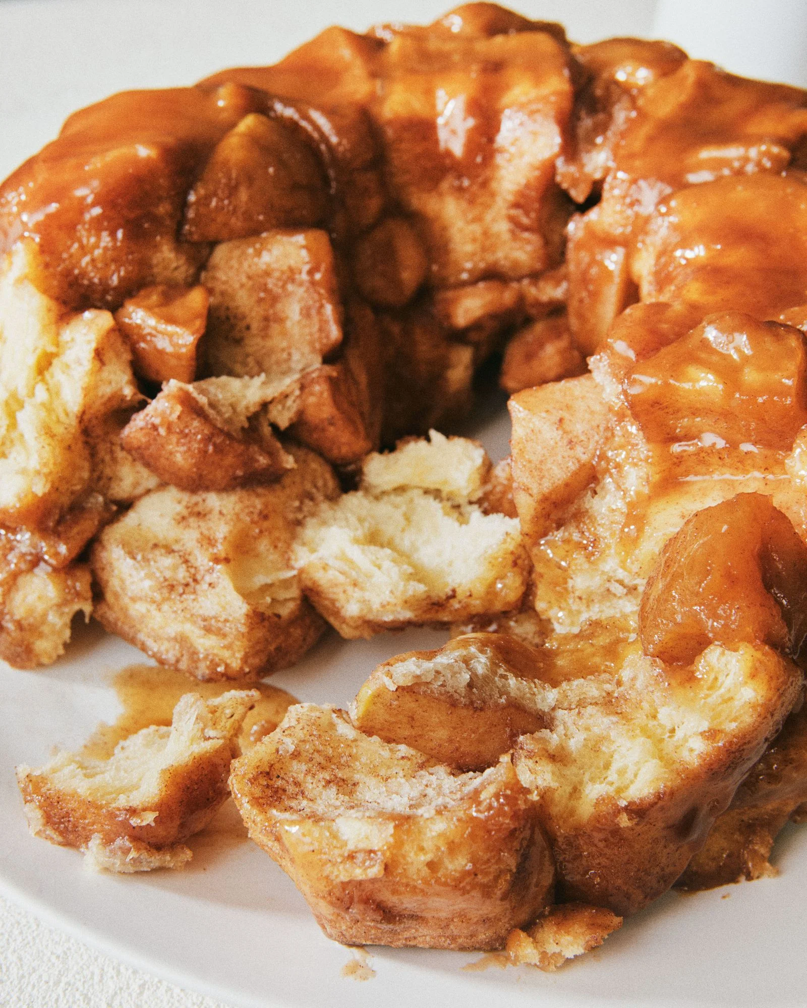 Monkey bread with caramelized apples and topped with caramel sauce.