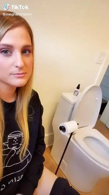 Meghan sitting on a toilet and panning to the second toilet next to her