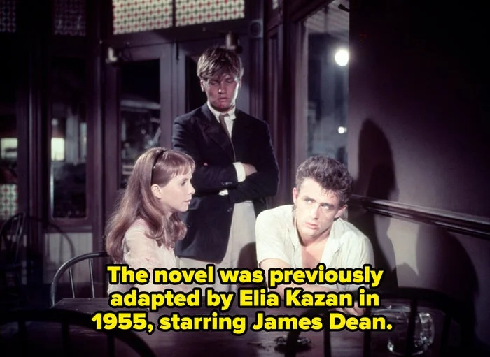 Three people sit tensely at a table in a classic film scene, with an atmosphere of drama and contemplation