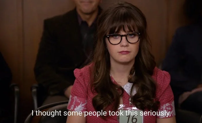 Person wearing glasses sits in an audience looking serious. Caption reads, "I thought some people took this seriously."