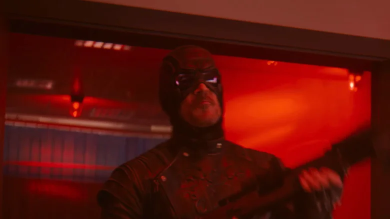 Todd Stashwick as Paladin coming through a doorway with a gun in his hand in VisionQuest
