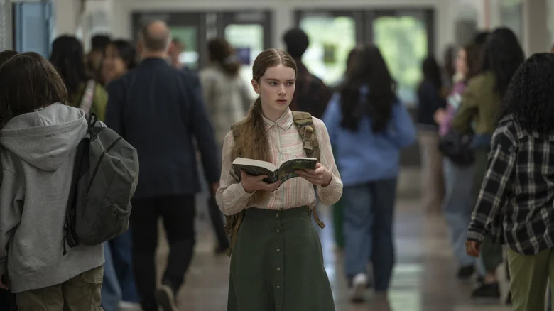 Carrie holds a book in the school hallway in Carrie (2026)